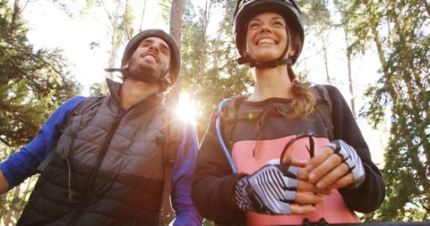 Smiling Cyclists Enjoying Nature and Adventure Outdoors