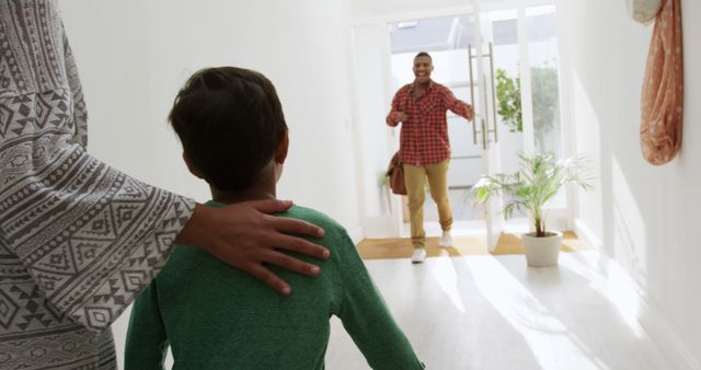 Child excitedly greeting returning parent at home - Download Free Stock Images Pikwizard.com