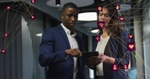 Business colleagues reviewing tablet with digital network overlay in modern office