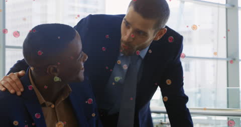 Businessmen Engaged in Animated conversation with Digital Graphics