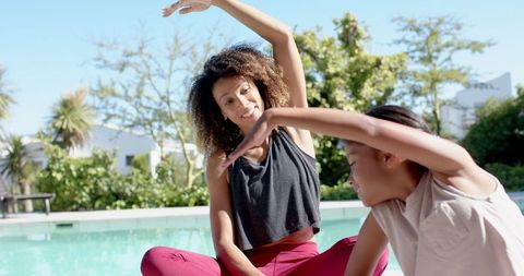 Mother and Daughter Yoga Bond by Pool in Sunlit Garden