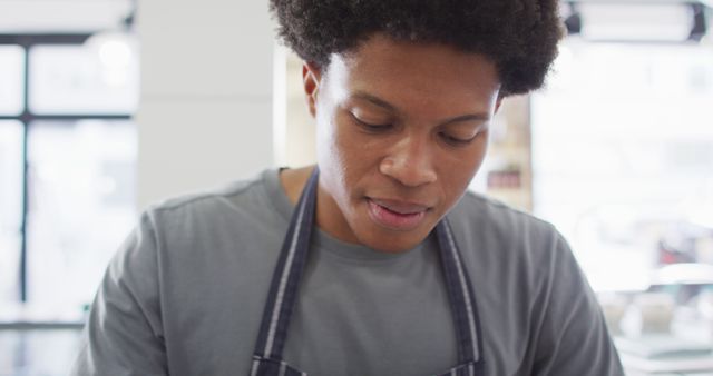 Young African American chef focused while cooking in kitchen - Download Free Stock Images Pikwizard.com