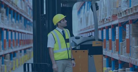 Warehouse Supervisor Monitoring Inventory with Electric Forklift