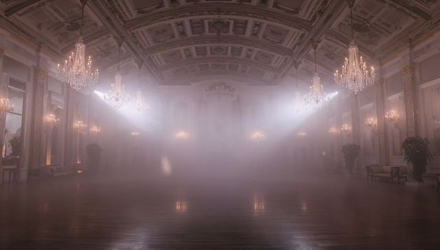 Empty grand ballroom glowing in mist with crystal chandeliers and dramatic light shafts