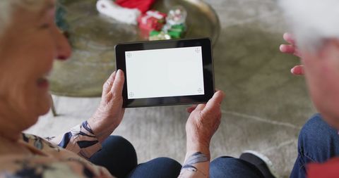 Senior Couple Using Tablet at Christmas Celebration - Download Free Stock Images Pikwizard.com