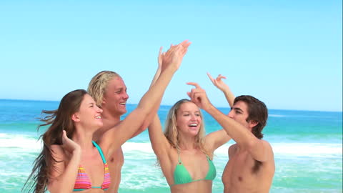 Friends Enjoying a Beach Party with Sun and Waves