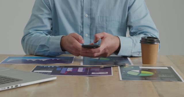 Businessman Analyzing Reports on Smartphone at Office Desk - Download Free Stock Images Pikwizard.com