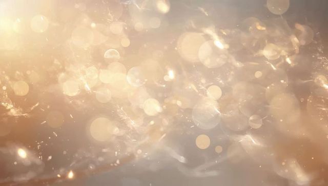 Golden bokeh light particles glowing abstract background ambient warm sparkle luxury glow