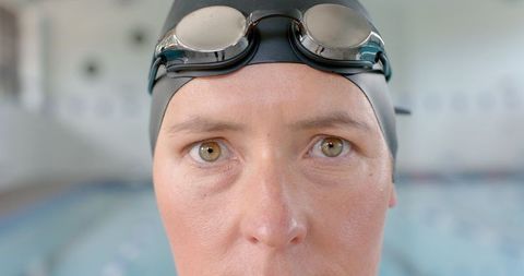 Caucasian Female Swimmer Preparing for Pool Workout with Goggles On