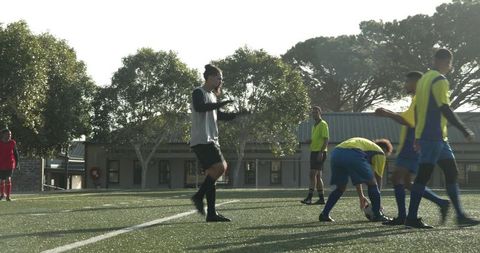 Teen Soccer Players Practicing Teamwork and Coordination on Field