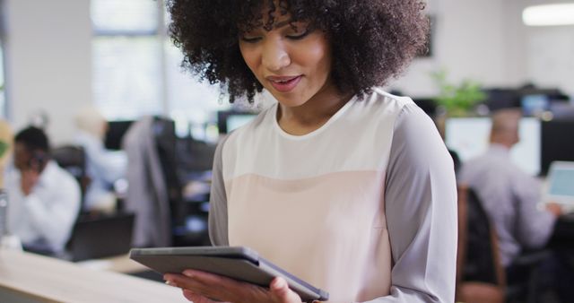 Businesswoman Using Digital Tablet in Modern Office Environment - Download Free Stock Images Pikwizard.com