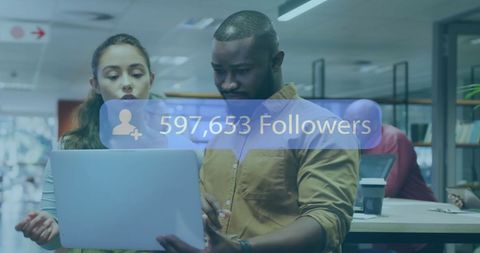 Diverse Professionals Analyzing Social Media Growth Metrics in Office