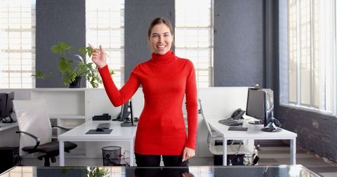 Confident Businesswoman Gesturing in Modern Office
