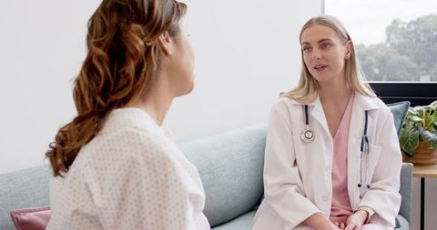 Female doctor consulting patient in clinic offering compassionate care and medical advice