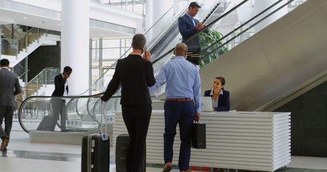 Business professionals in office attire are checking in at a modern reception desk. Some are using the escalator while one man with a suitcase greets the receptionist. Ideal for illustrating business travel, office interiors, company reception areas, and corporate environments.