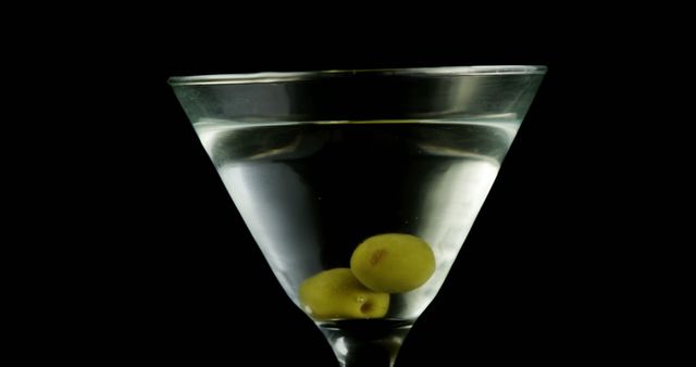 Martini Glass with Two Green Olives on Black Background - Download Free Stock Images Pikwizard.com