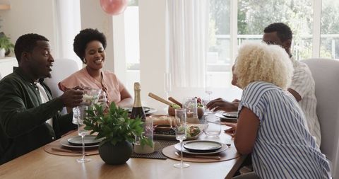 Friends Sharing Joyful Conversation During Home Lunch Gathering