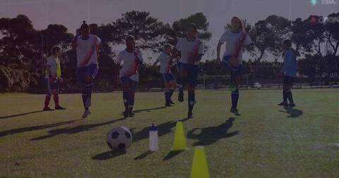 Soccer players performing warm-up drills on field