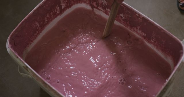 Close up view of potter mixing paint in a container at pottery studio - Download Free Stock Photos Pikwizard.com