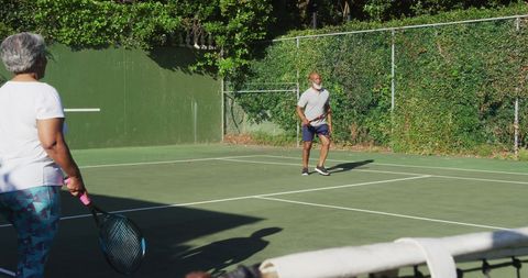 Active Senior Couple Engaging in Tennis Game on Sunny Day - Download Free Stock Images Pikwizard.com