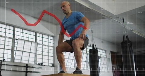 Mid-adult man performing plyo box step-up in industrial gym with data chart overlay