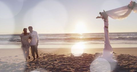 Beach Wedding Newlyweds Walking at Sunset