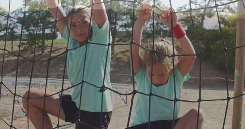 Children Climbing Rope Net on Outdoor Obstacle Course