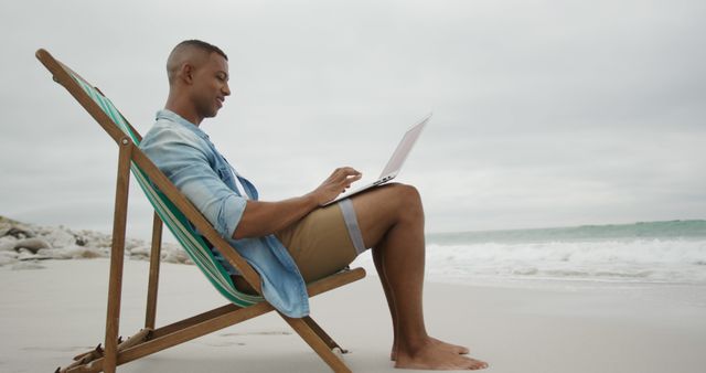 Man Relaxing on Beach While Working on Laptop - Download Free Stock Images Pikwizard.com