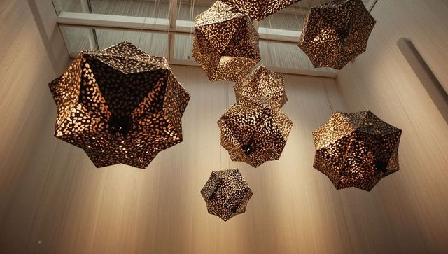 Geometric pendant lights hanging beneath skylight
