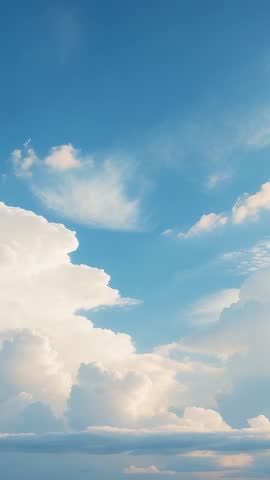 Vertical Cinematic Sky: Cumulus Clouds Billowing Across Blue Sky with Soft Light