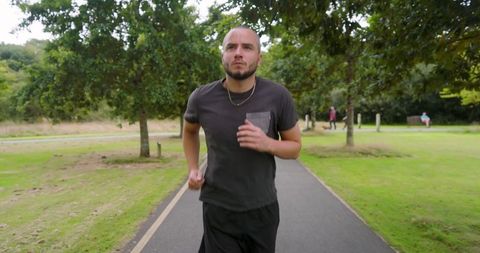 Confident Man Jogging on Scenic Park Path for Health and Fitness - Download Free Stock Images Pikwizard.com