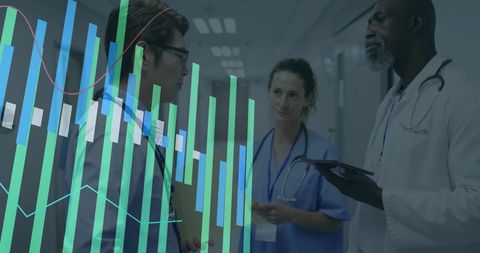 Healthcare Innovators Analyzing Data Trends in Hospital Corridor