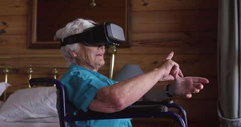 Senior Woman in Wheelchair Using VR Headset at Home