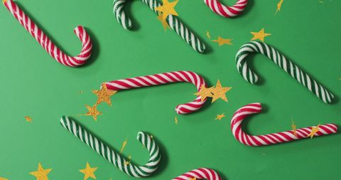 Festive Candy Canes and Gold Stars on Green Background - Download Free Stock Images Pikwizard.com