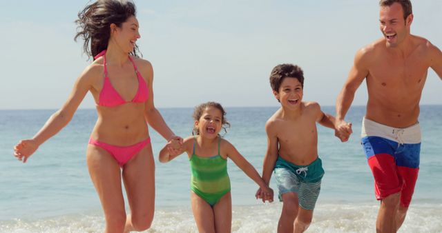 Happy Family Enjoying Beach Vacation and Running by the Shore - Download Free Stock Images Pikwizard.com