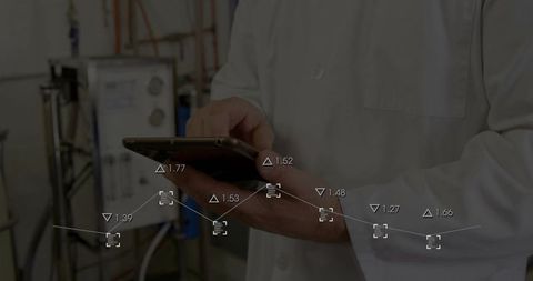 Lab technician tapping tablet with real-time data overlay in industrial bioprocess facility