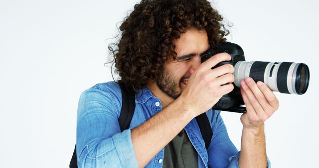 Young Male Photographer Focusing Through Camera Lens in Studio - Download Free Stock Images Pikwizard.com