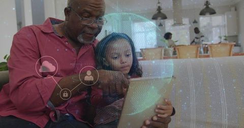 Grandfather Teaching Granddaughter Tablet Learning with Digital Hologram Globe at Home