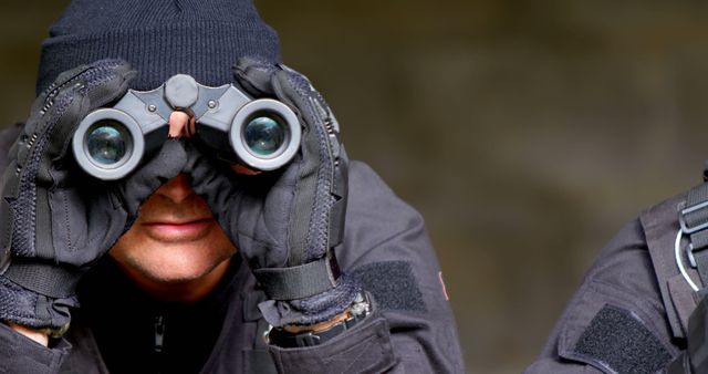 Tactical Officer in Black Gear Using Binoculars - Download Free Stock Images Pikwizard.com