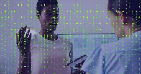Coworkers consulting with tablet and green binary code overlay showing cyber collaboration