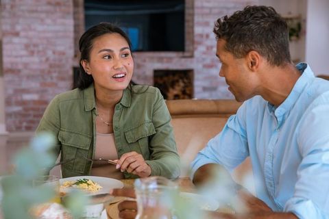 Couple Conversing While Dining in Cozy Interior Setting