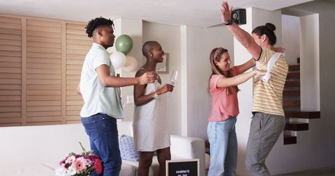 Friends Celebrating Achievement with Joy and Toast at Home