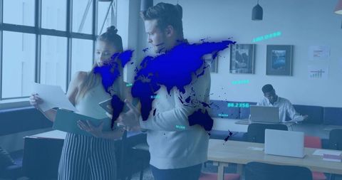 Coworkers reviewing global data overlay and collaboration in modern coworking workspace