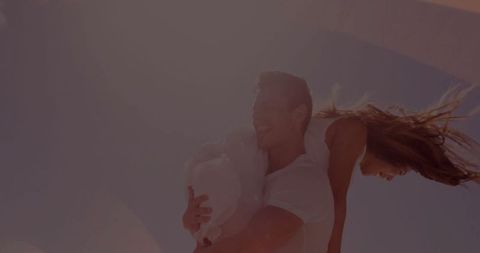 Couple embracing under sunny pergola expelling joyful vibes