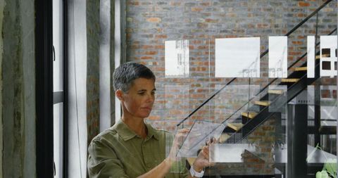 Female engineer using digital interface in modern office