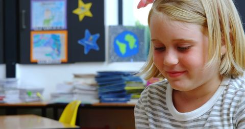 Young Girl Smiling While Using Tablet in Classroom - Download Free Stock Images Pikwizard.com