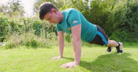 Man Performing Push-Ups Outdoors on Sunny Day for Fitness