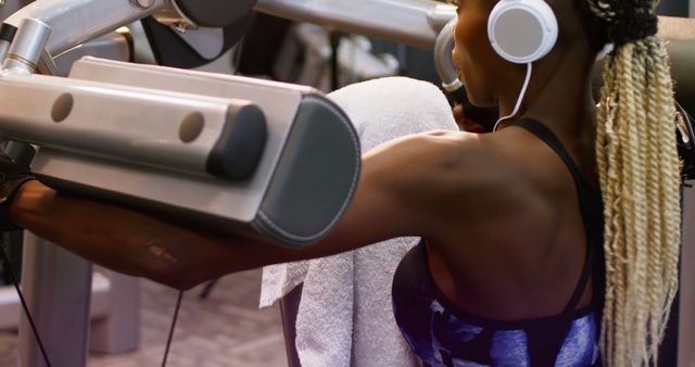 Focused Female Athlete Exercising on Leg Press Machine Listening to Music - Download Free Stock Images Pikwizard.com