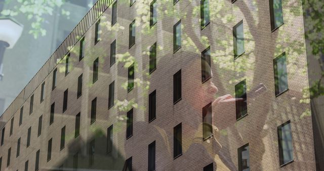 Businesswoman Reflecting Through Office Building Glass at Day - Download Free Stock Images Pikwizard.com