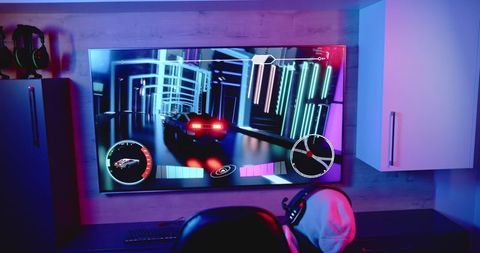 home gaming setup: player enjoying immersive racing game - Download Free Stock Images Pikwizard.com